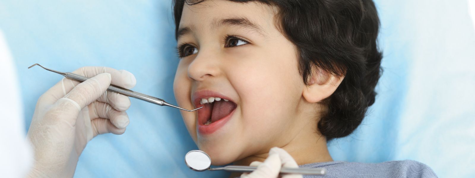 Small Boy happily at Dental while checking teeth